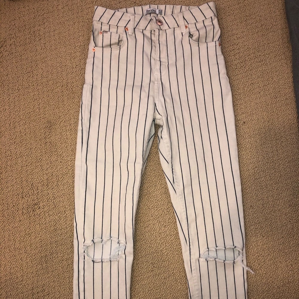 Pinstripe pants with rips in knees